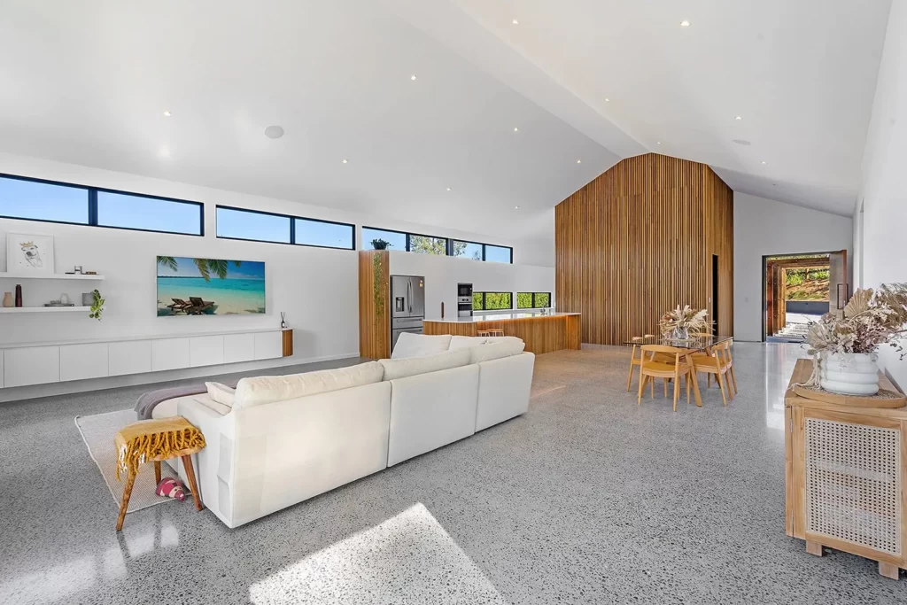 Polished concrete floor in a large open plan modern living area in a home.